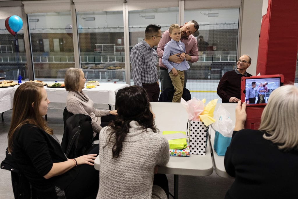 family taking video of celebration of dads with son on Adoption day in Cornwall