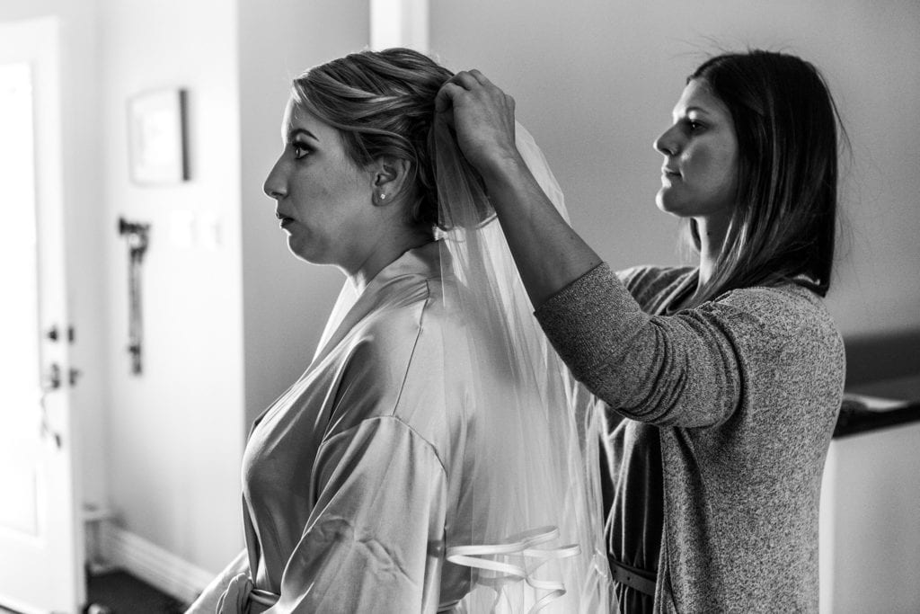 bride makes surprised face and veil gets fastened into hair