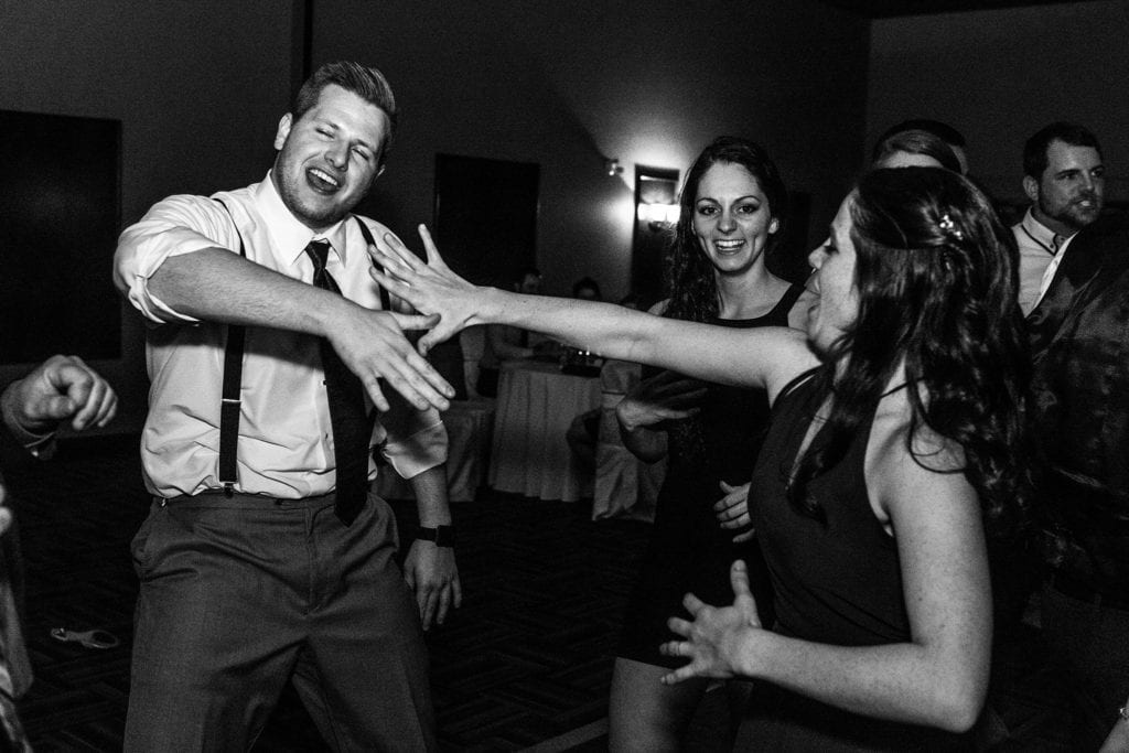 man dances with arm thrown in front of him as woman throws arm towards him