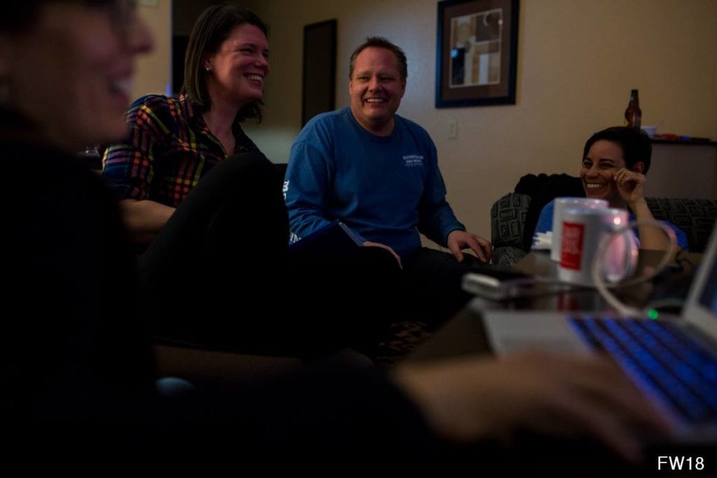 people sitting in hotel room laughing