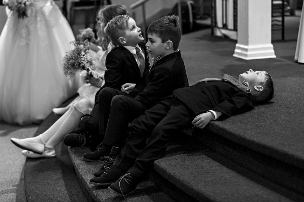 ring bearer lies down on sanctuary steps after Cornwall church ceremony