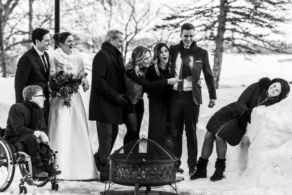 Family reacts in shock as mother falls in snowbank during Chateau Montebello wedding family formals