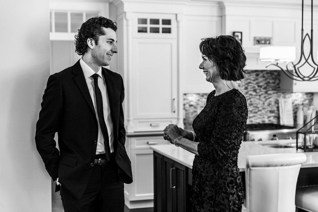 groom looks at mother after getting ready for wedding