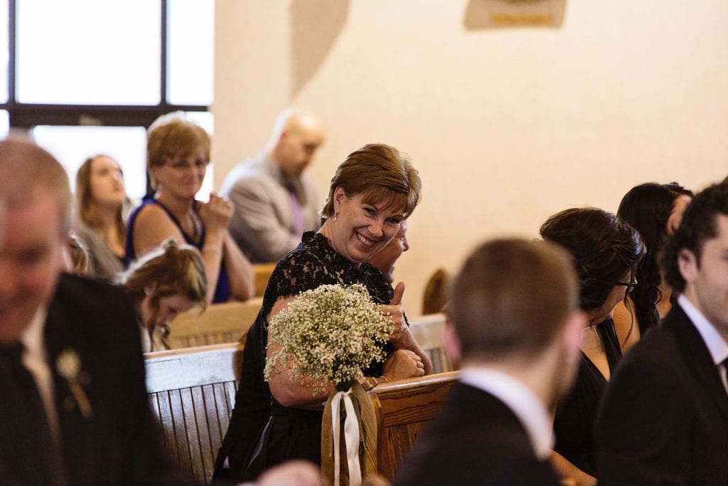 mother of the bride gives thumbs up during Cornwall wedding ceremony