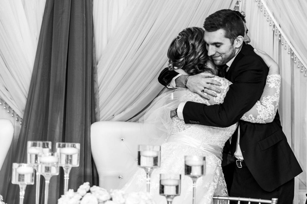 bride hugs best man after wedding toast