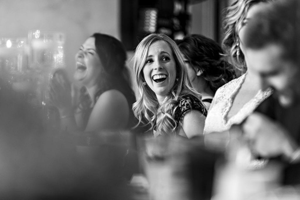bridesmaids laugh during toasts
