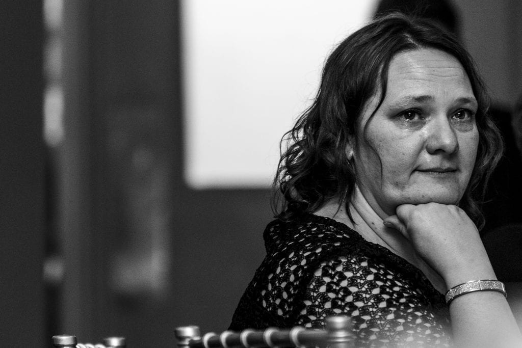 woman cries while resting chin on face during Best Western Cornwall wedding reception