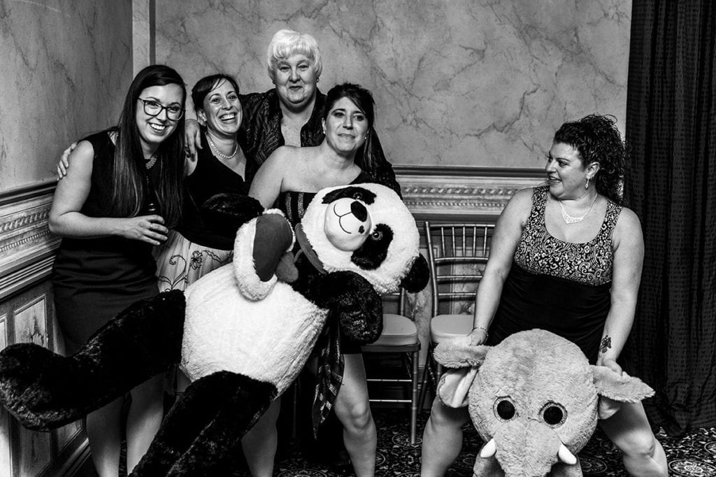 wedding guests sit on oversized stuffed animals