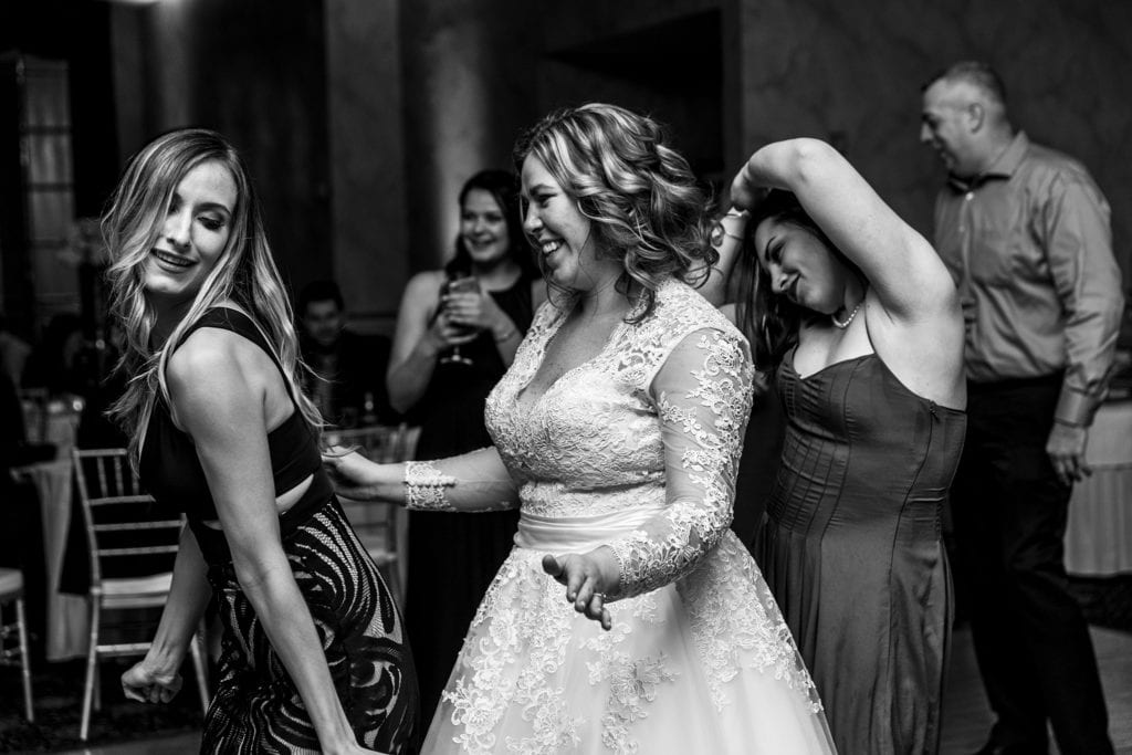 bride dances with two friends