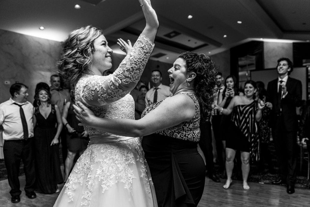 wedding guests dances with face close to bride's boobs
