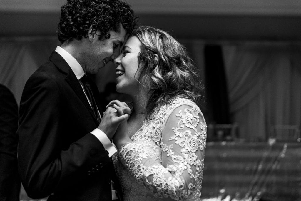 bride and groom dance holding hands with faces pressed together during Best Western Parkway Cornwall wedding reception