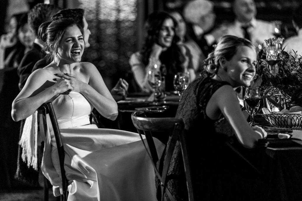 bride laughs while hold hands to her chest