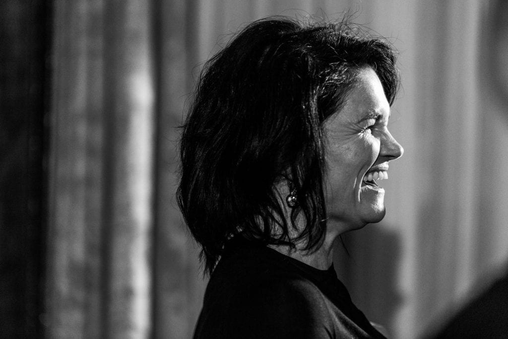 woman in black dress laughing