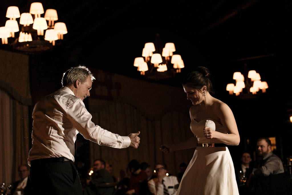 bride and father twist during first dance