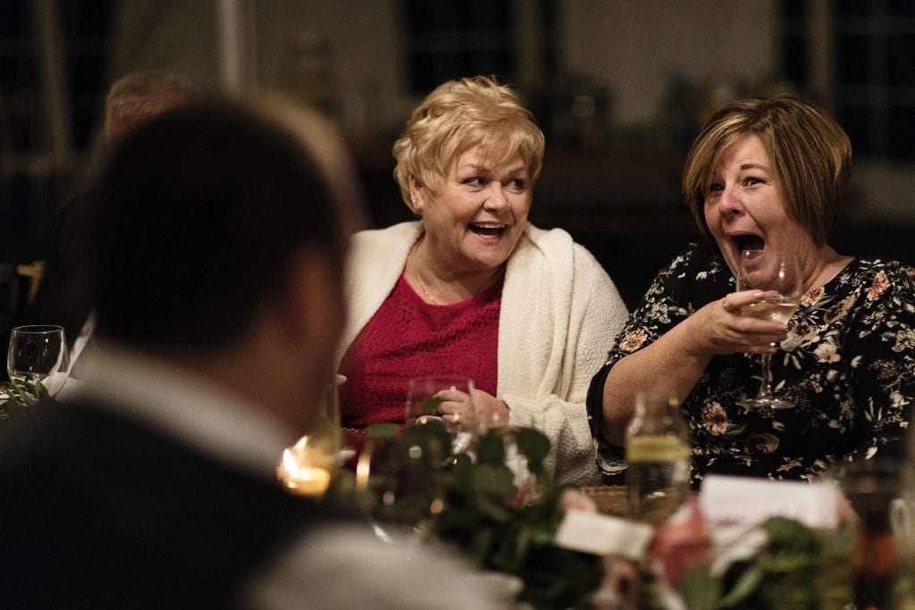 mothers laugh together during dinner