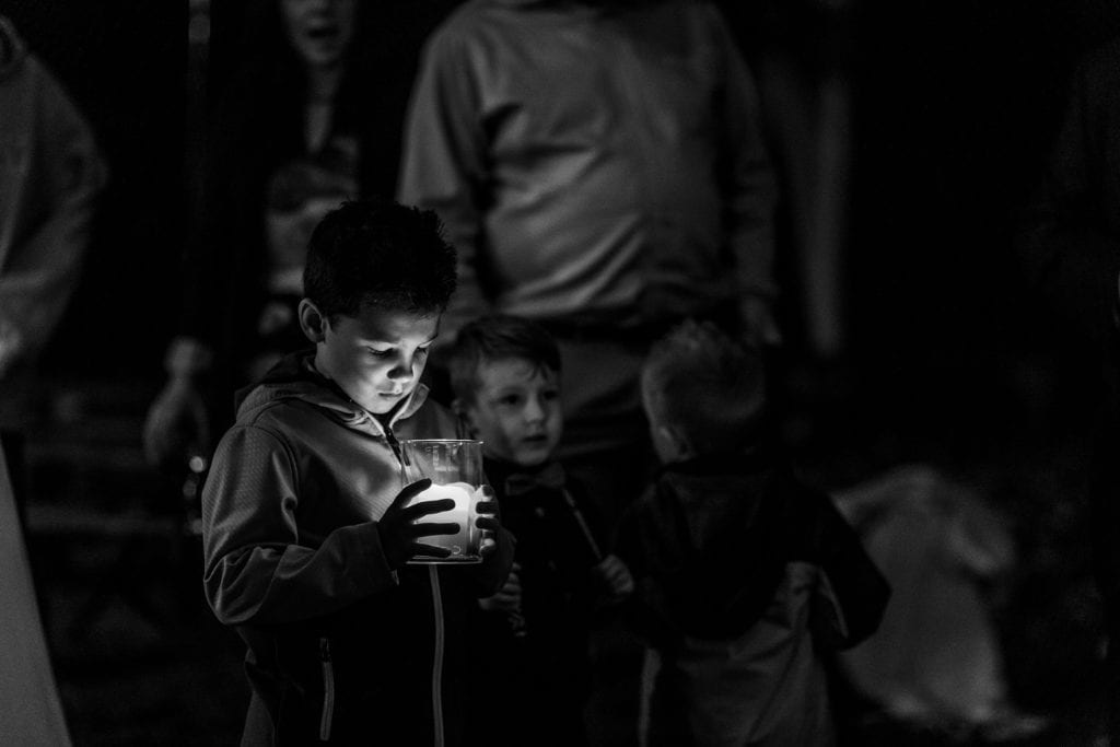 boy looks into candle