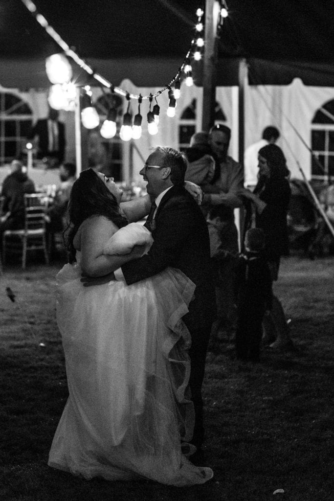 bride and uncle laugh during first dance