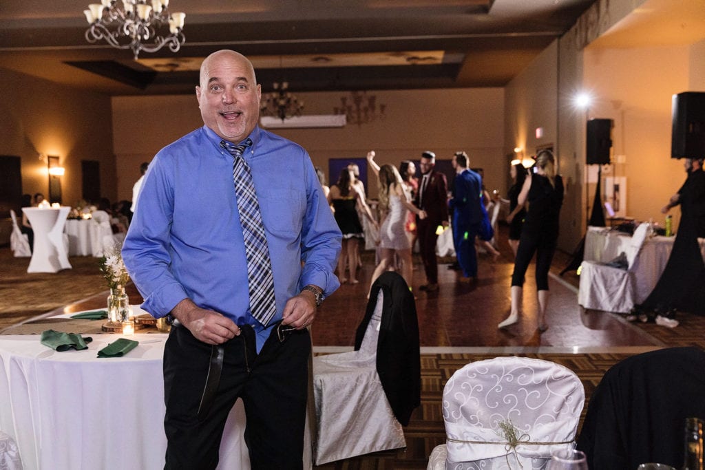 man stands with pants undone looking surprised