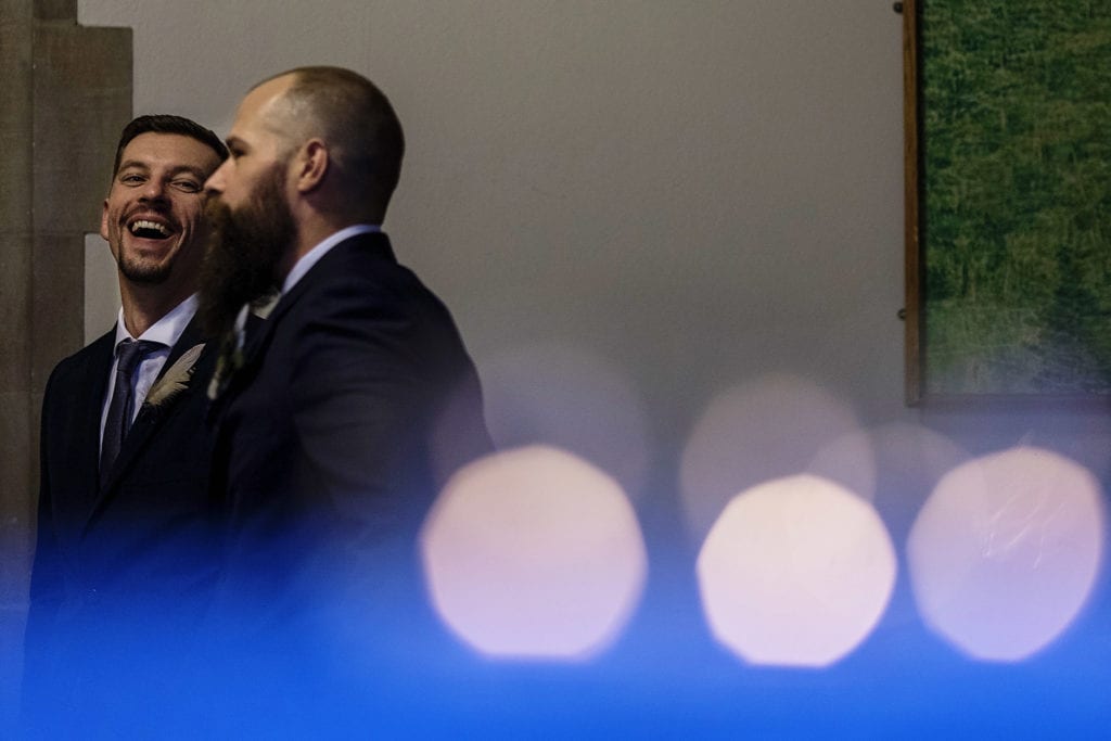 groomsman laughs with groom 