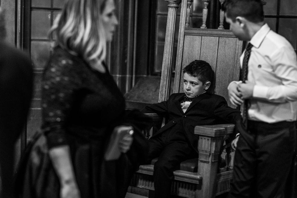 boy looks bored while sitting in throne