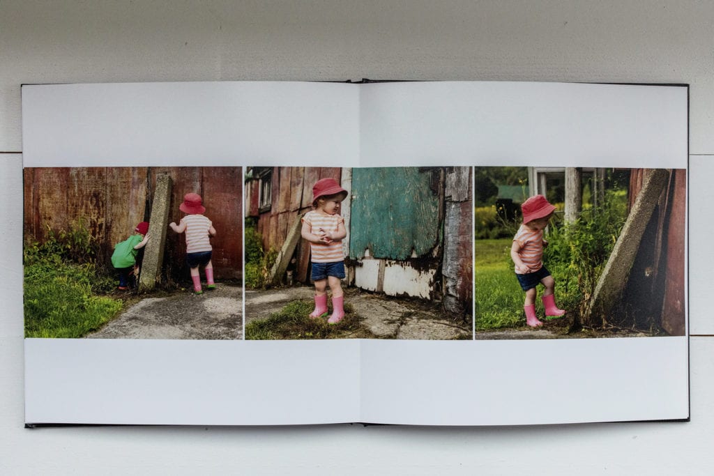 documentary family photography album pages featuring girl looking for kitten outside barn