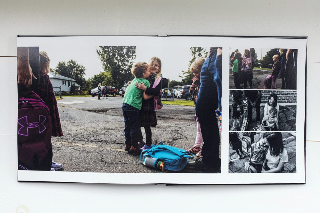 documentary family photography album pages featuring boy hugging friend on first day of school