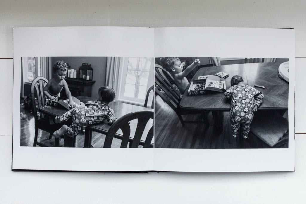 documentary family photography album pages featuring toddler hanging from edge of table