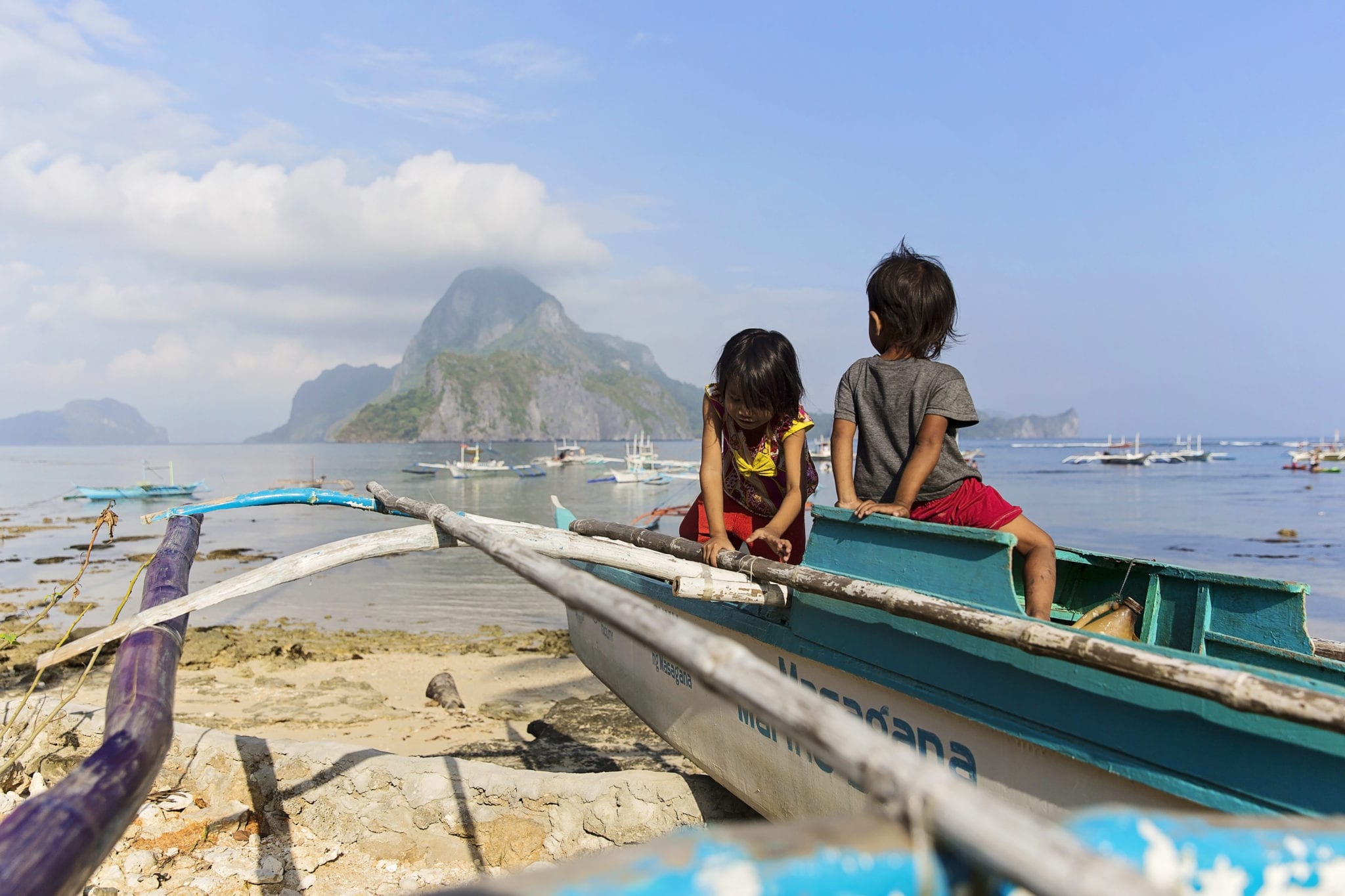 children playing in boat near sea