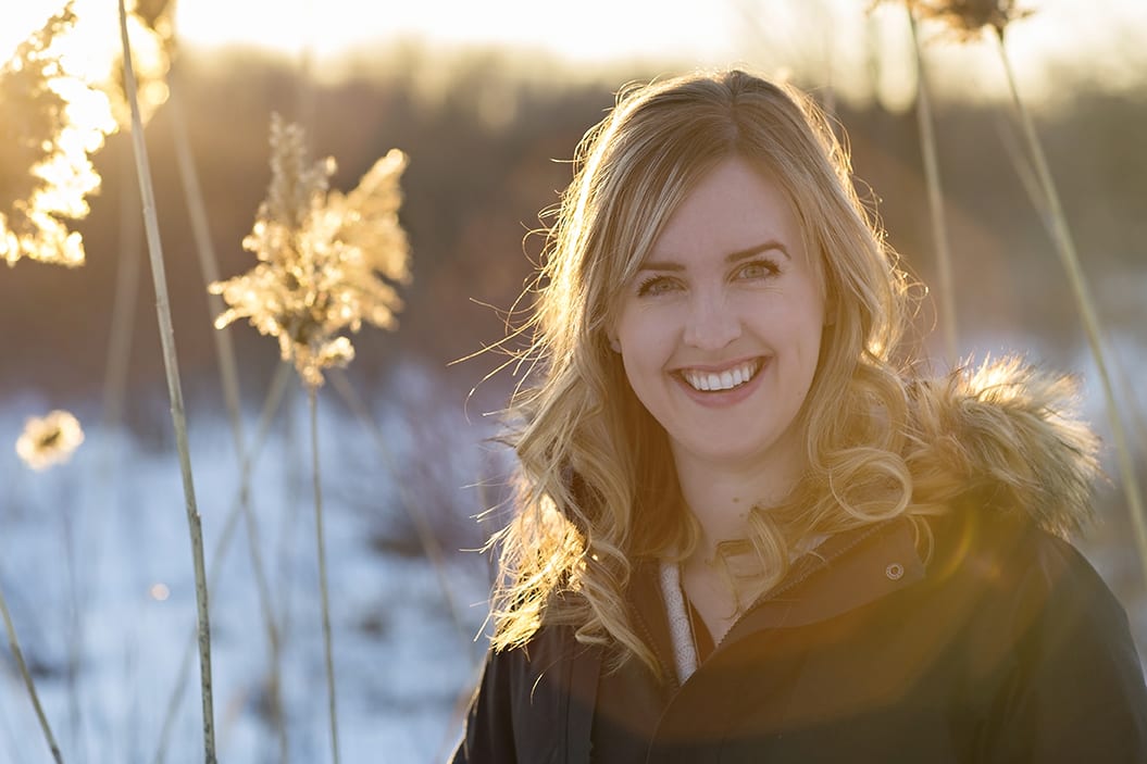 Cornwall wedding photographer assistant in tall winter grass