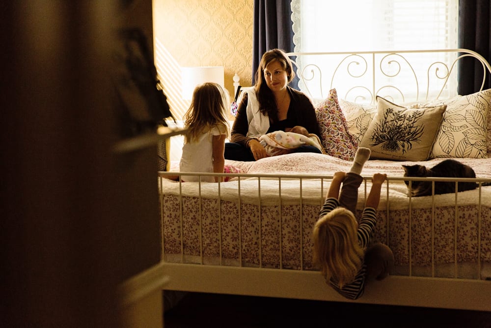 Cornwall family photographer - sisters in bedroom with mom
