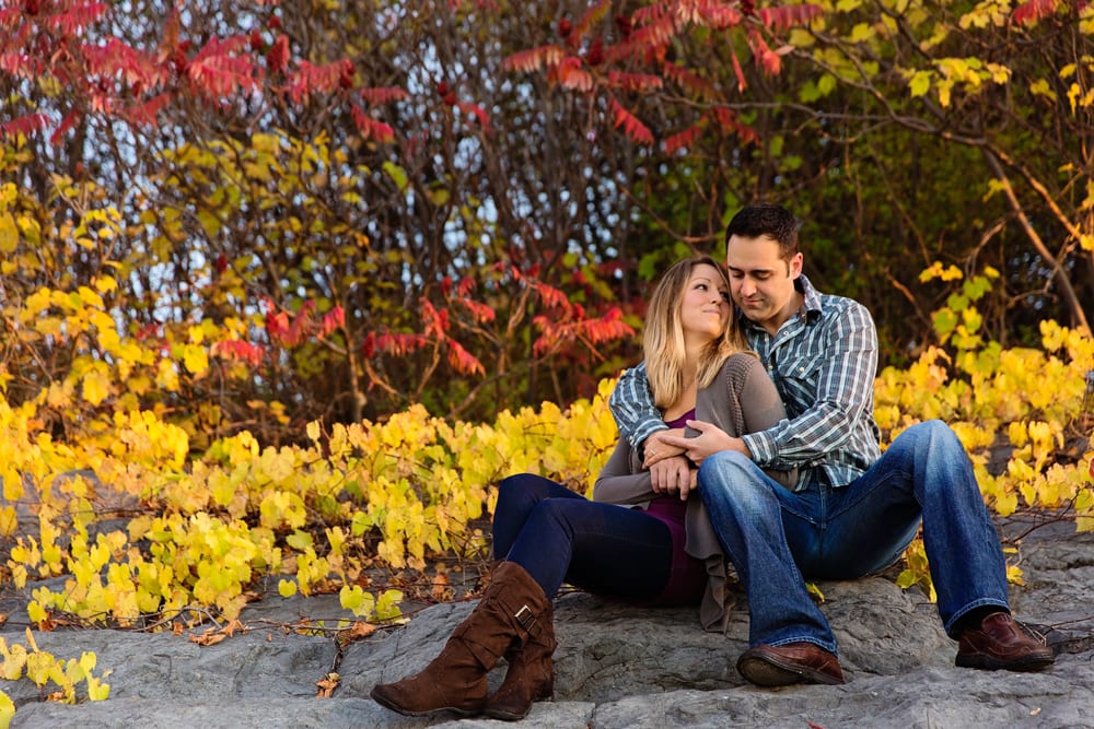 Ontario wedding photographer - couple cuddling for Cornwall engagement photos along the St Lawrence River