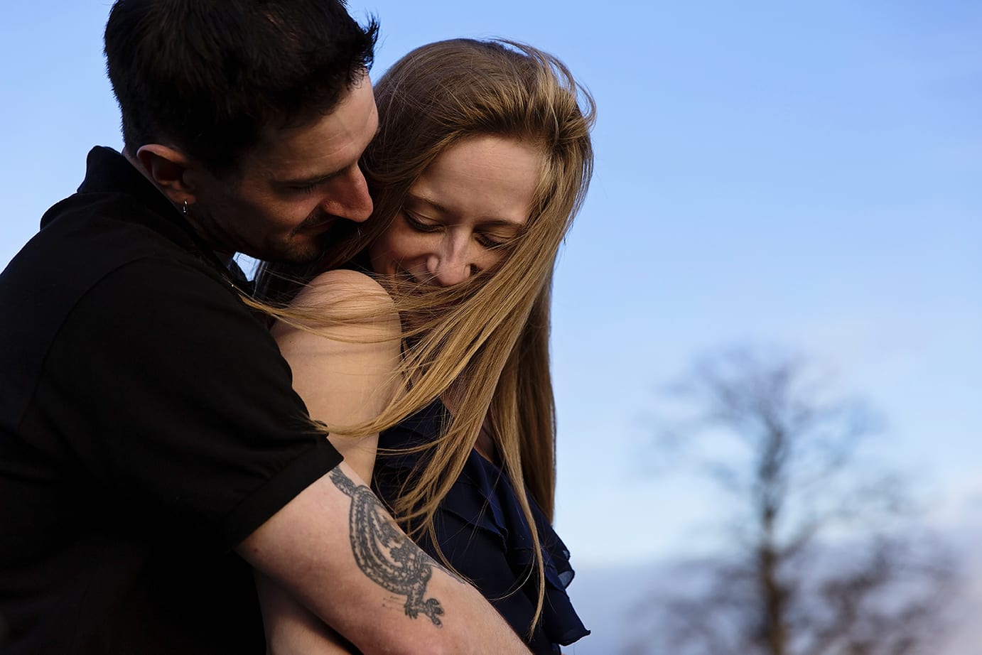 laughing while hugging during Cornwall engagement session