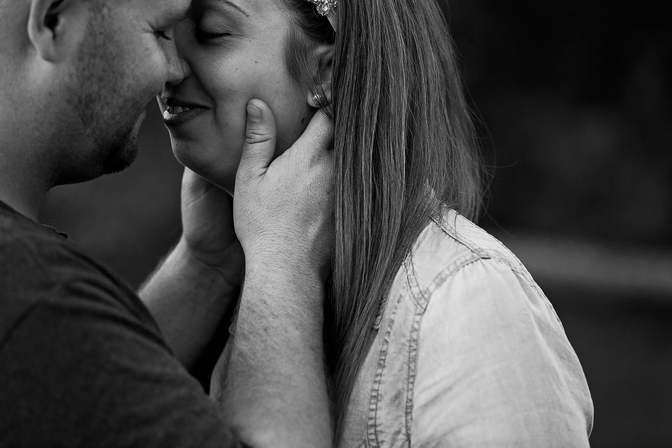 man leans in close to fiancee during St Raphael's engagement session