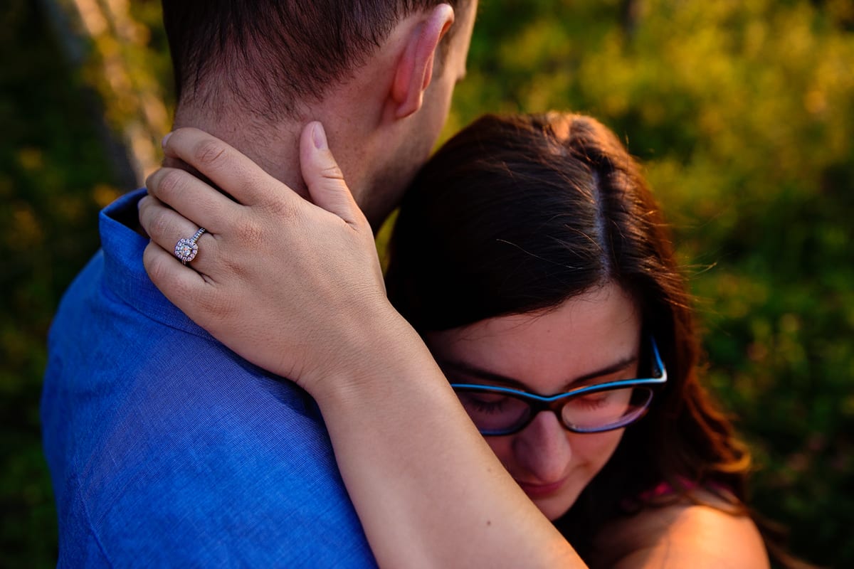 Woman wearing glasses in sunset engagement session