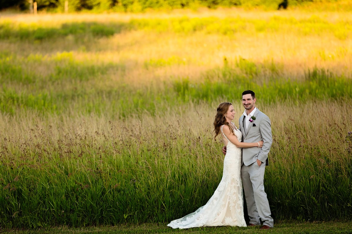 Bride and groom in field of tall grass at intimate Strathmere wedding