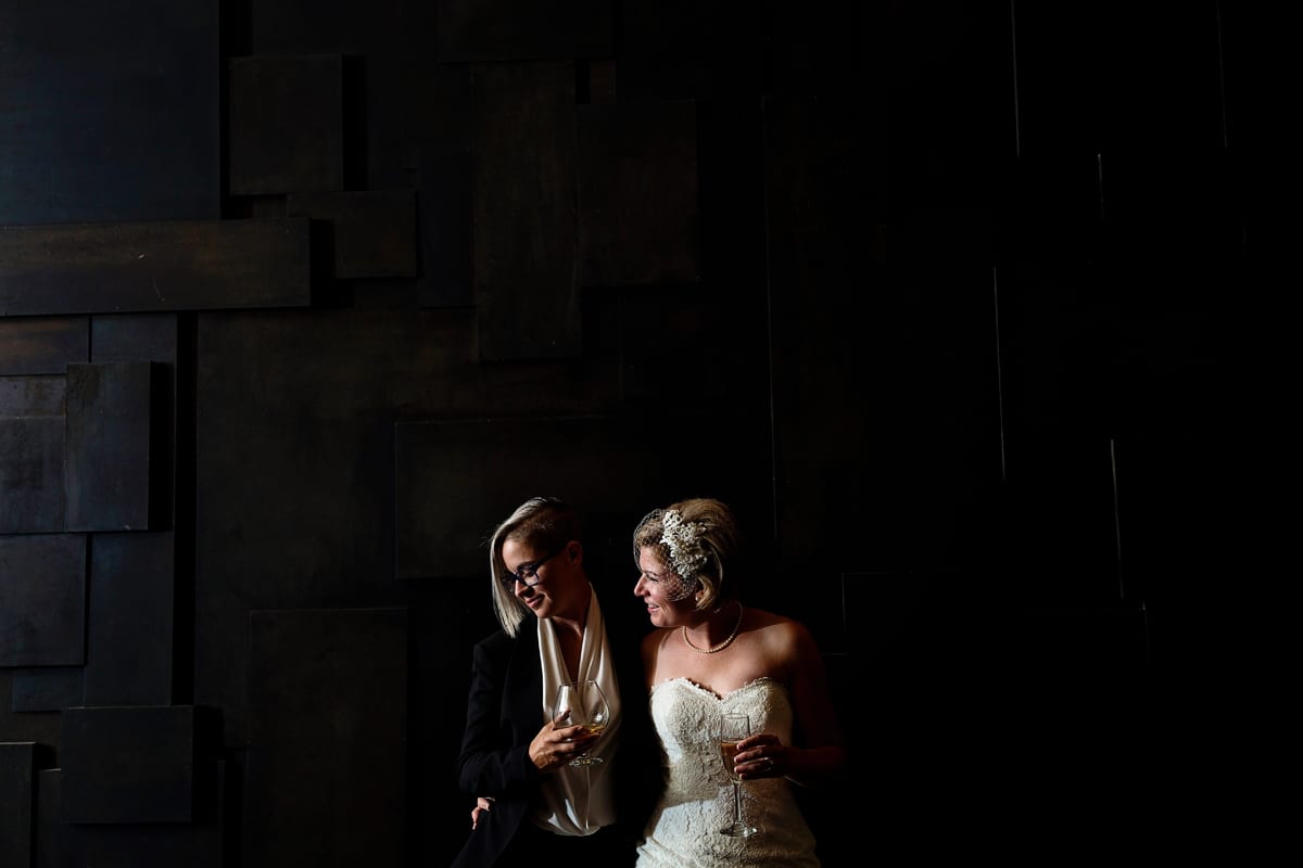 LGBTQ wedding brides on unique geometric black background