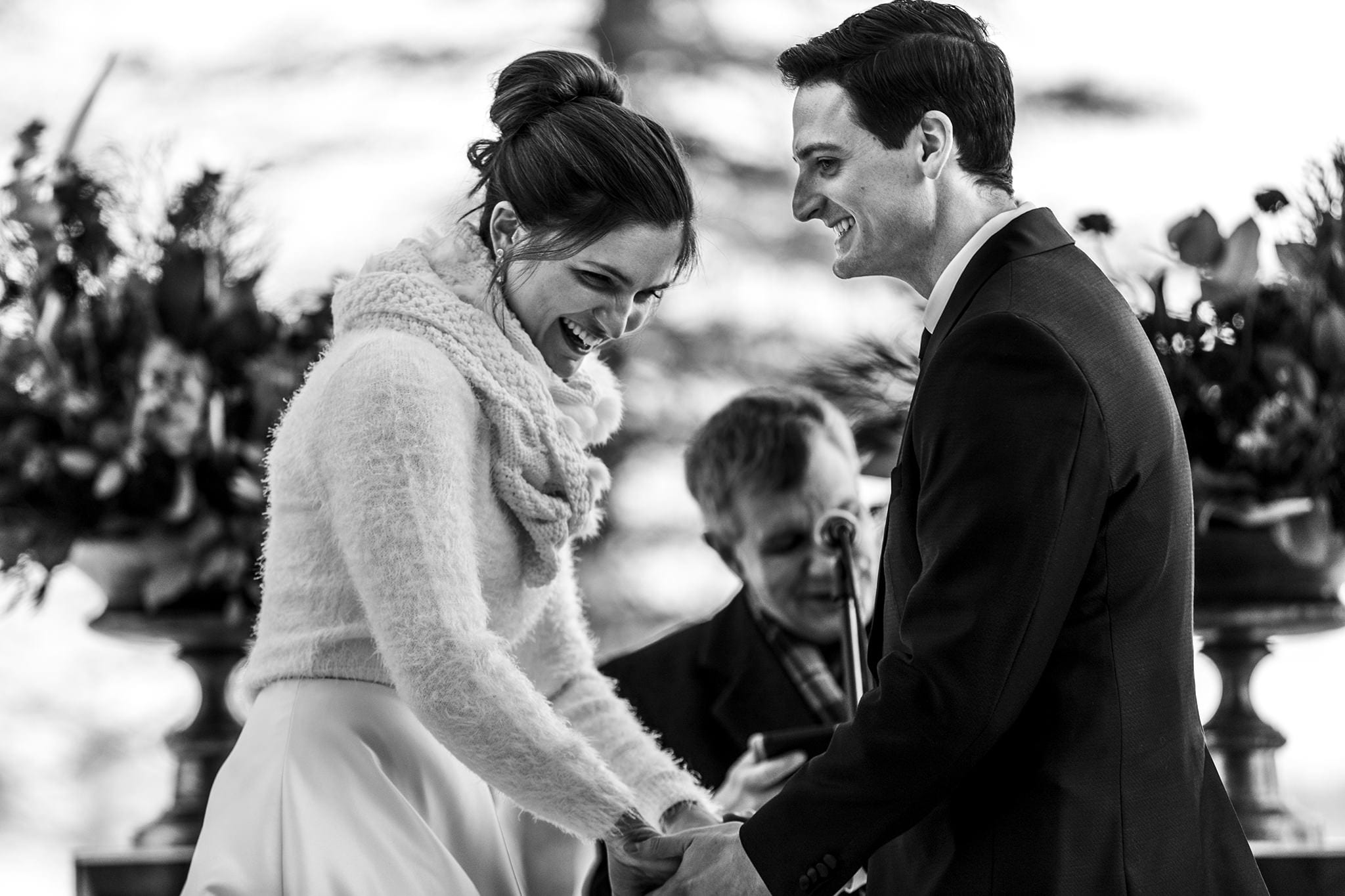 bride and groom laugh during wedding ceremony