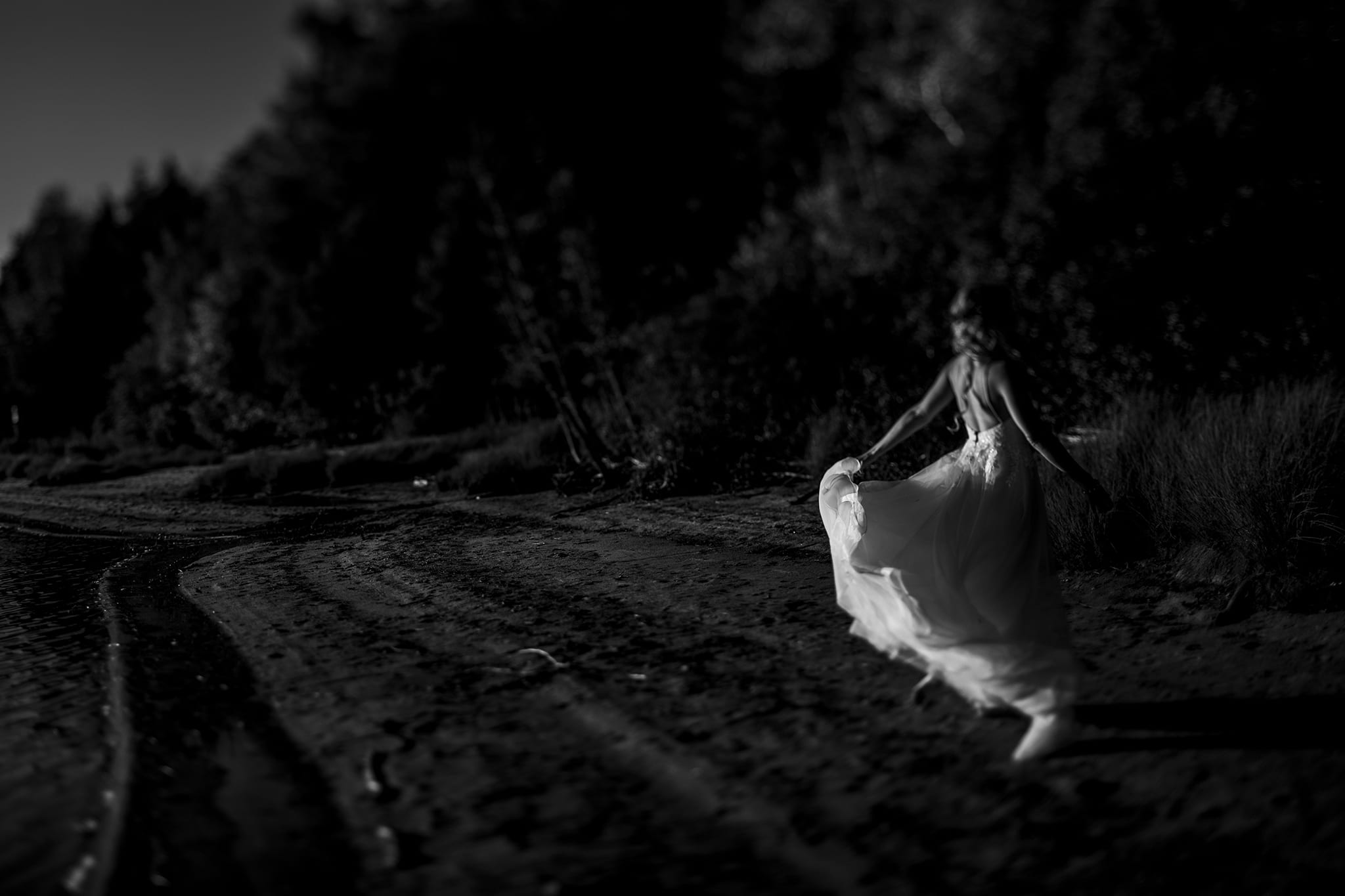 Haliburton bride runs along shoreline while swirling her dress