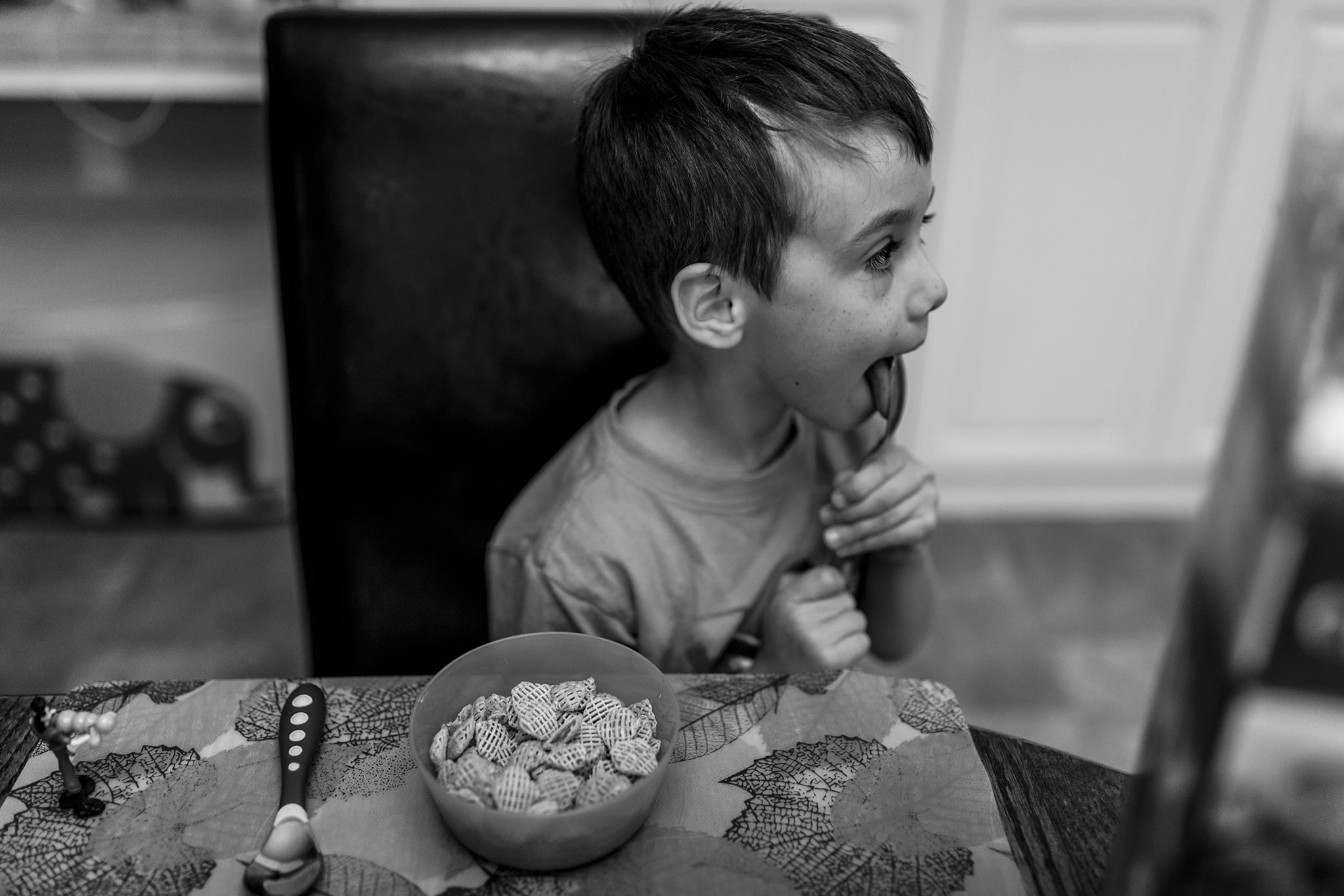 boy licks breakfast spoon