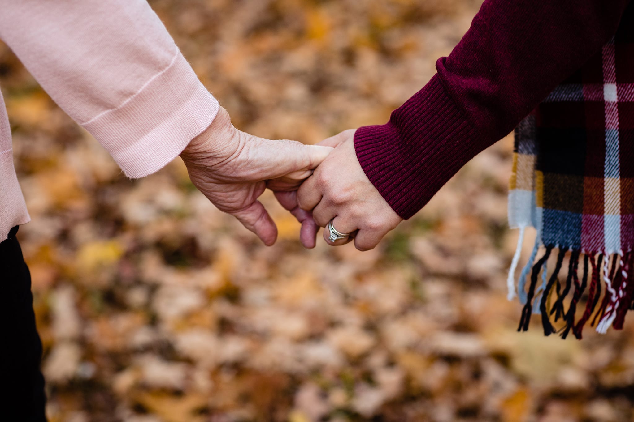 younger hand holds older hand