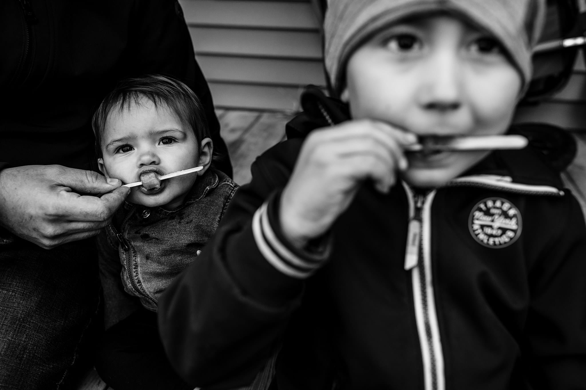 toddler and brother eat popsicles