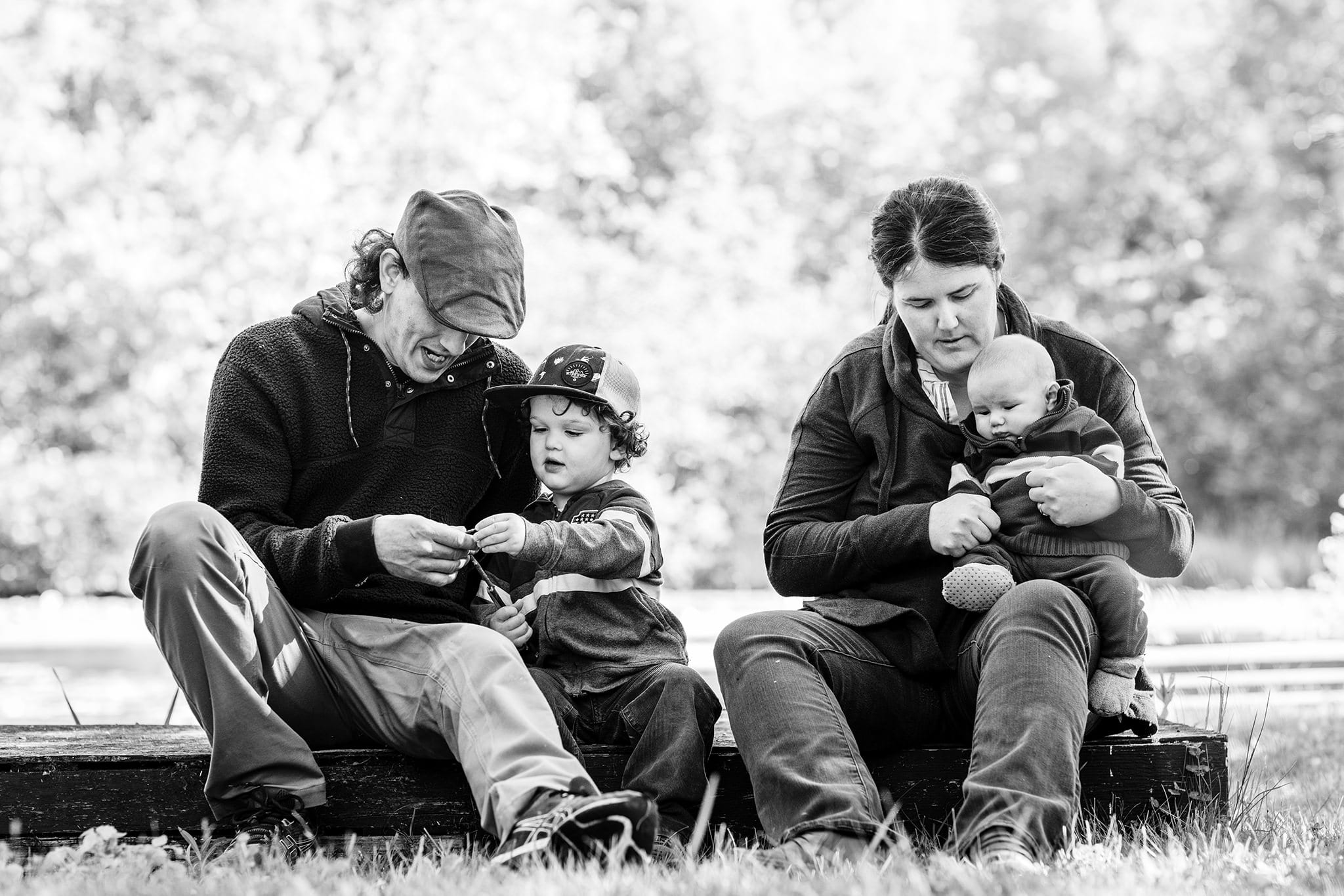 Lancaster parents look at things with young boys while sitting on dock