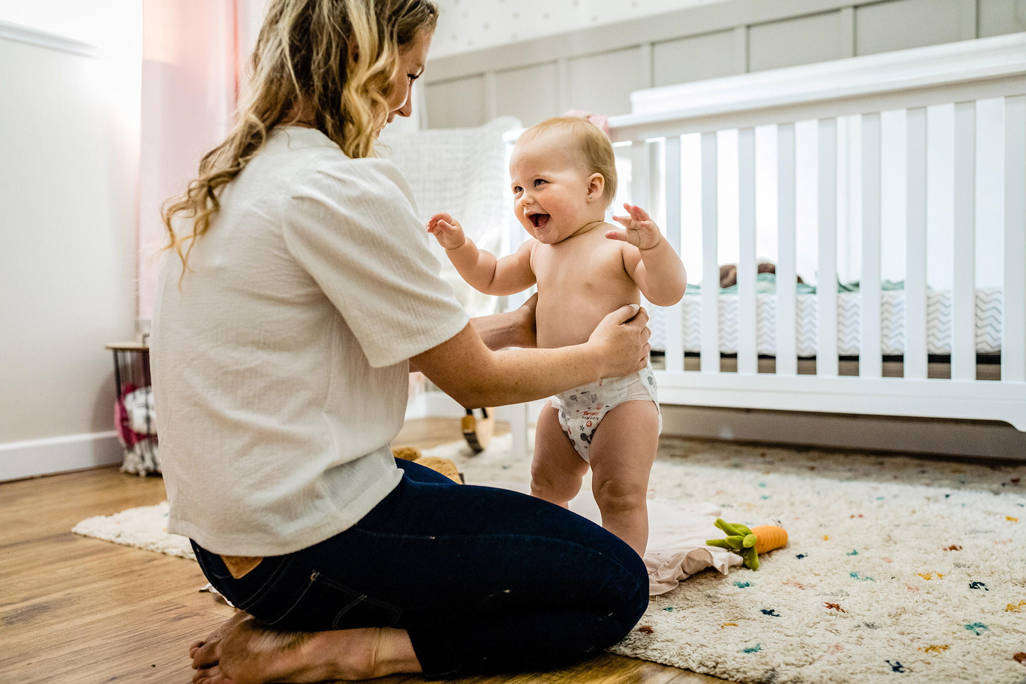 Mother and daughter on floor smiling