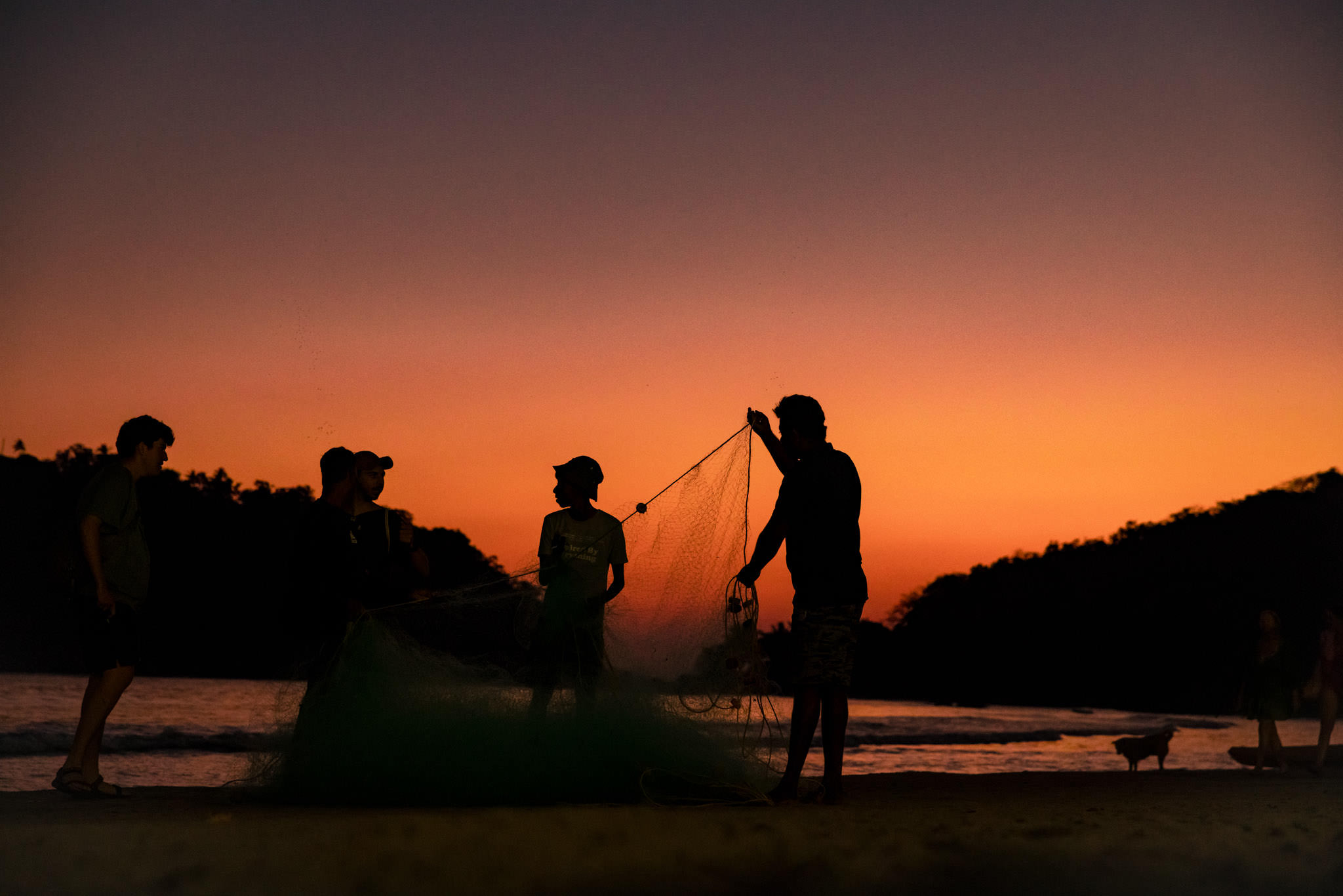 fisherman tidy their net on Palolem Beach in Goa